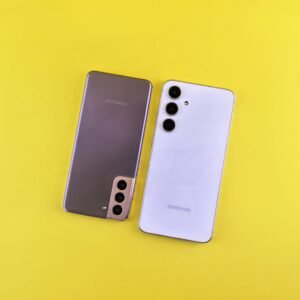 Pair of modern smartphones displayed on a vibrant yellow background highlighting sleek design.